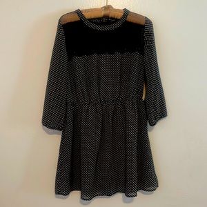 Black & white polka dot mini dress with sheer black lace accents on the top.